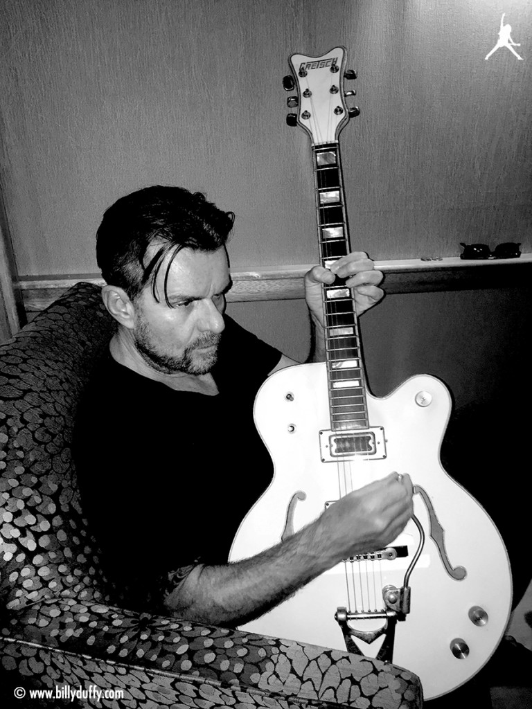 Billy Duffy with Gretsch White Falcon in a comfy chair!