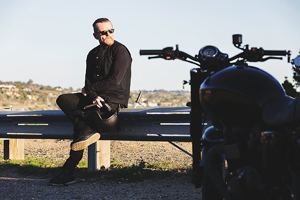 Billy Duffy and his black Triumph motorcycle
